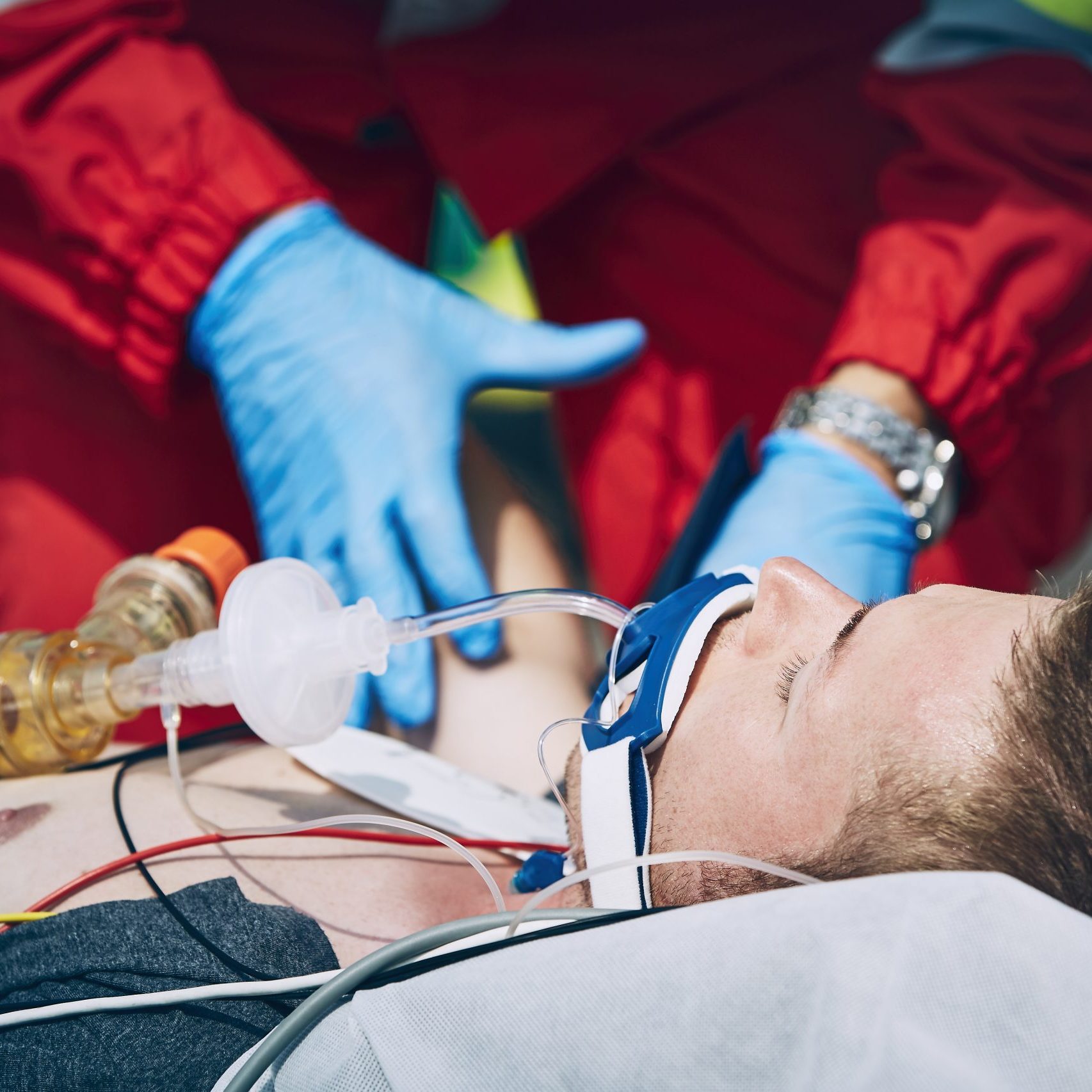 Paramedic of emergency medical service helping man after cardiopulmonary resuscitation. Themes help, hope a health care.
