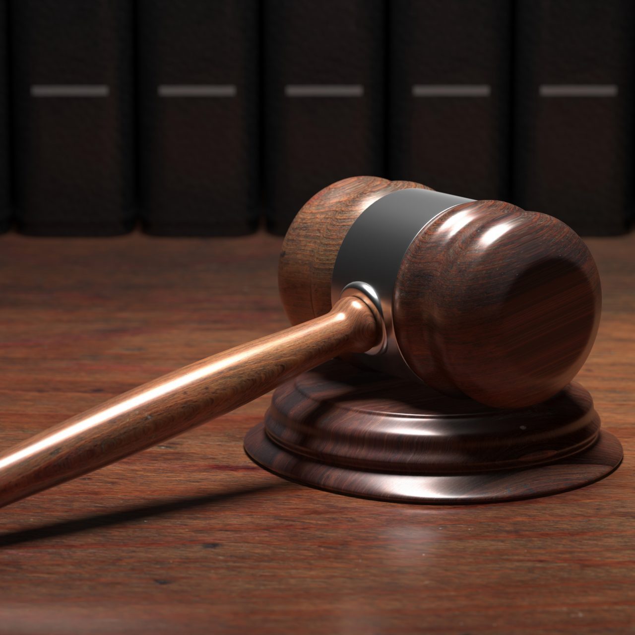 Judge gavel on wooden desk, law books background Lawyer office, courthouse, legislation concept. 3d illustration